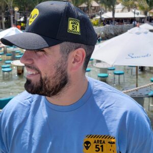 a man wearing a hat and a blue shirt