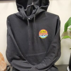 a black hoodie sitting on top of a wooden table