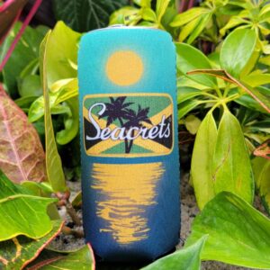 a blue and yellow bottle sitting in the middle of some plants