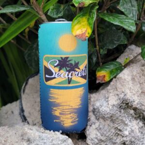 a blue can sitting on top of a rock next to a bush