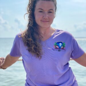a woman standing on a boat in the ocean