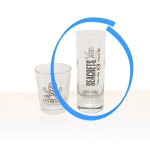 a shot glass and a shot glass sitting on a table