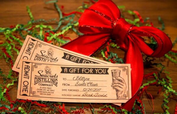 a pair of tickets sitting on top of a wooden table