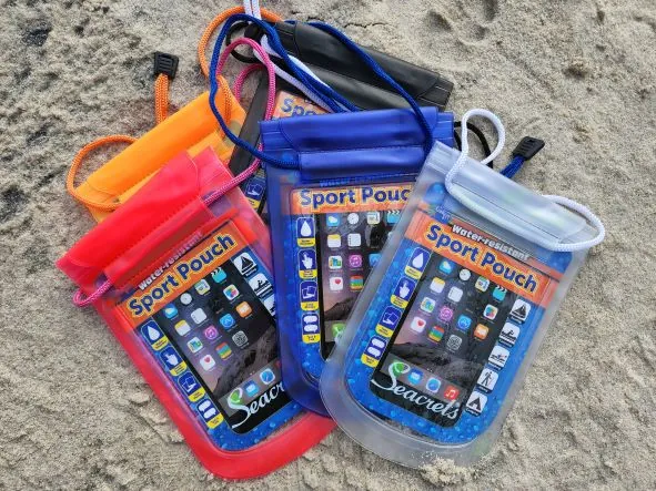 a group of cell phones sitting on top of a sandy beach