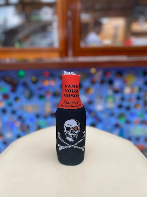 a bottle with a skull on it sitting on top of a cake