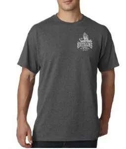a man wearing a grey t - shirt with a crown on it