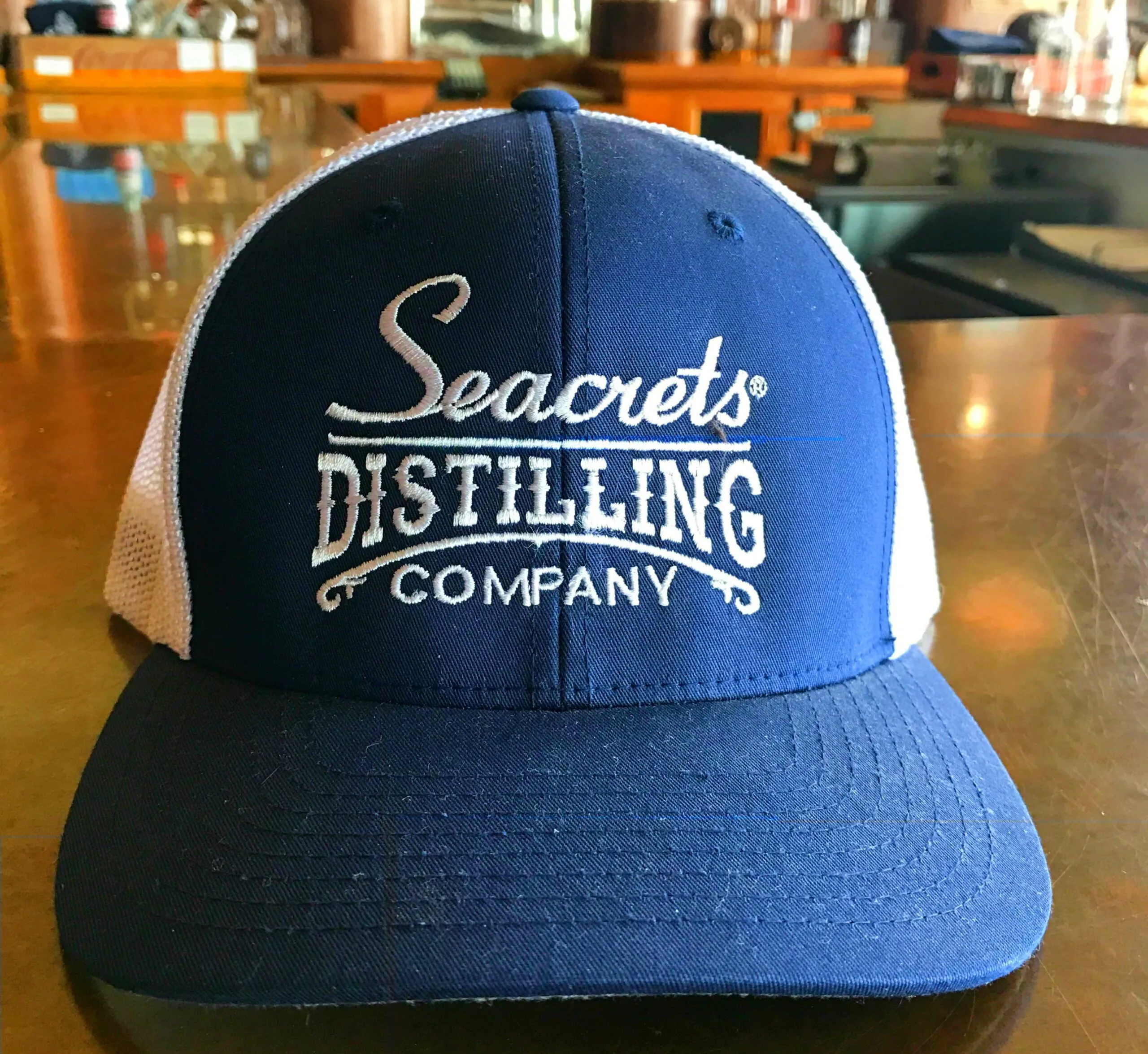 a blue and white hat sitting on top of a wooden table