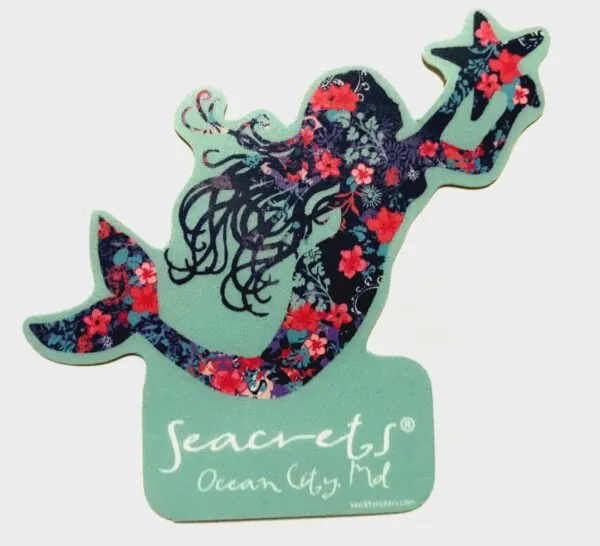 a sticker of a mermaid with flowers on it