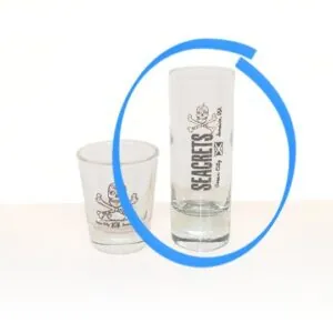 a shot glass and a shot glass sitting on a table